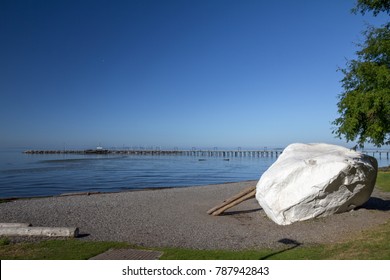 White Rock, Canada - July 31, 2014: A glacial erratic and the subject of local myth gives its name to the seaside community of White Rock.  This "City By The Sea" is a suburb of Vancouver, BC, Canada 