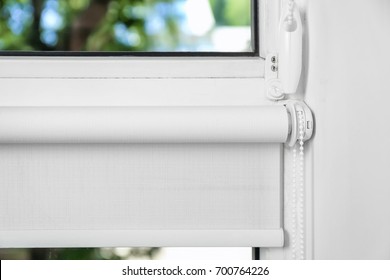 White Roller Blind On A Metal Plastic Window