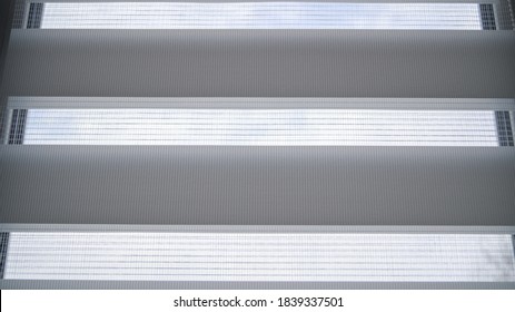 White Roller Blinds With Stripes And Mesh On A Plastic Window In The Room. Day And Night System. It's A Nasty Day. Comfort And Refinement Of The House.