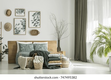 White Room With Floral Bedding On King-size Bed And Window With Khaki Curtain