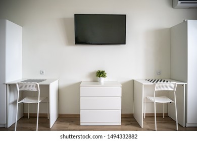 White Room Interior With TV On Wall, Two White Tables And Chairs, Minimalist Style.