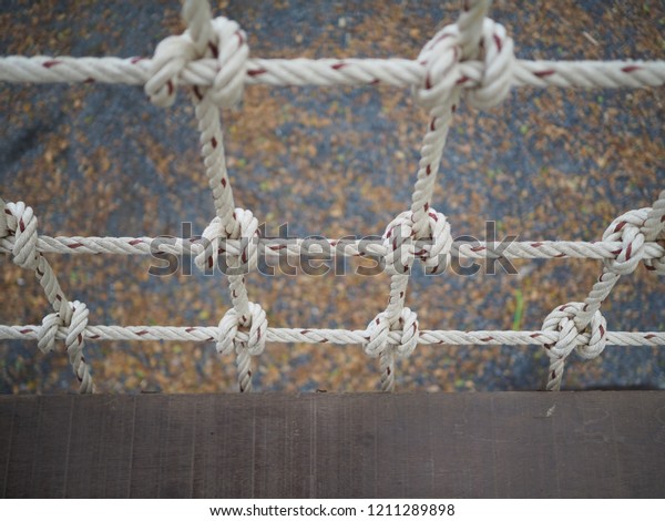 White rope of\
the bridge make a floor from a\
wood