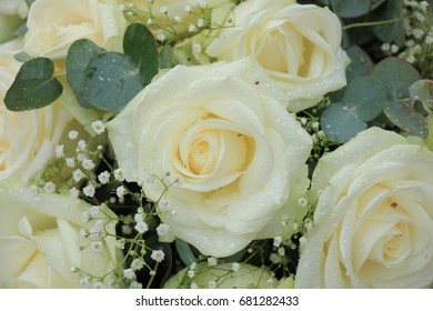 White roses and baby's-breath in a floral wedding decoration - Powered by Shutterstock