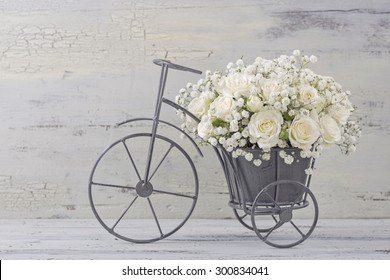 White Roses In A Bicycle Vase