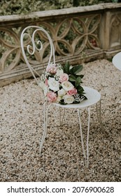 White Roses Wedding Bouquet On A Metal Romantic Chair 