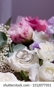 white roses and wedding rings