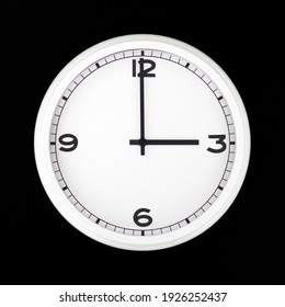 White Round Analog Wall Clock Isolated On Black Background, Its Three Oclock.