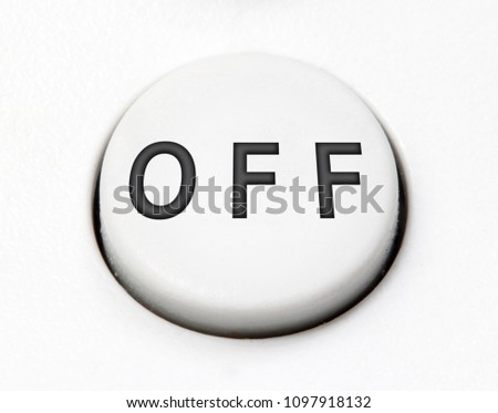 A white round button switch - off, close up. Control mechanical key for end - turn off on control device.