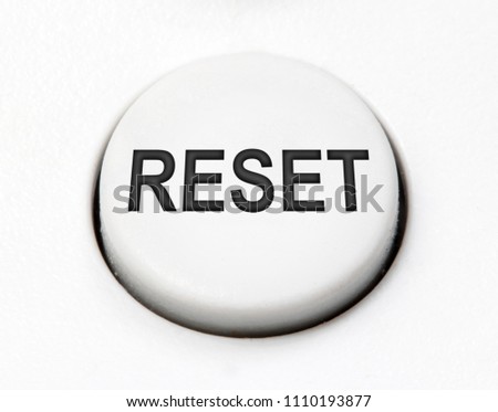 A white round button switch for reset close up. Control mechanical key for select idea of user on control device.
