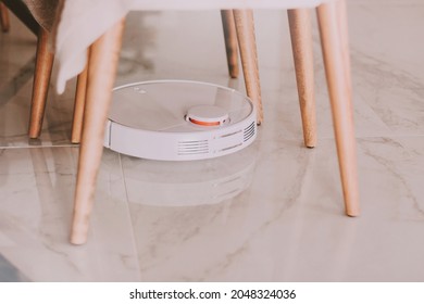 White Round Hoover Cleaner Robot Cleaning Floor At Home. Housekeeping. Removing Dust And Dirty. Smart Technologies