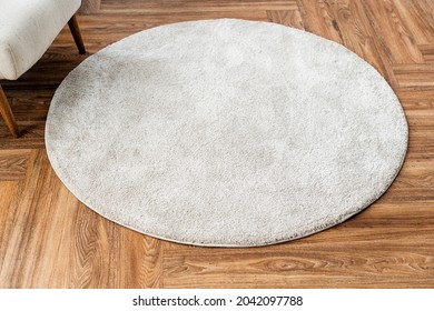 White Round Rug On Wooden Floor