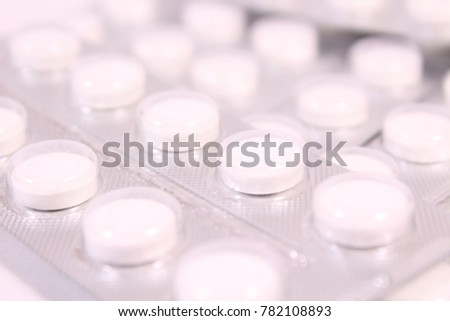 White round tablets in a package. Background. Texture.