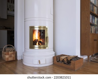 White Round Wood Burning Stove In Living Room. Firewood In Box. Heating With Wood Concept. 