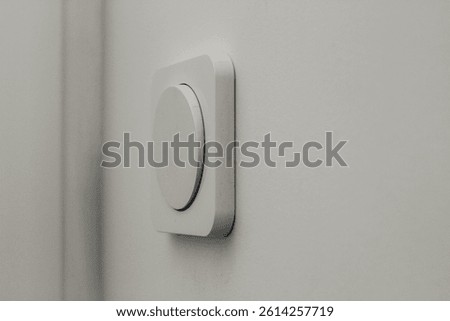 A white round-type light switch