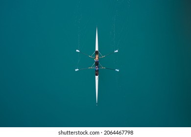 White rowing boat in motion with two women, top view. Top view of the rowing race. Aerial view of rowing. Rowing on the water aerial view. - Shutterstock ID 2064467798