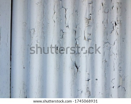 White rustic abstract design background chipped paint flaking corrogated metal sheet