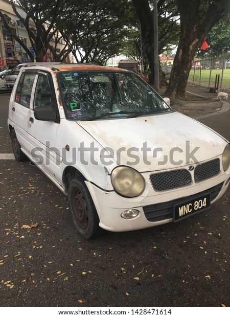 White and Rusty Old Junk Car. Vintage\
Car still Eoad worthy. Kuala Lumpur Malaysia June\
2019
