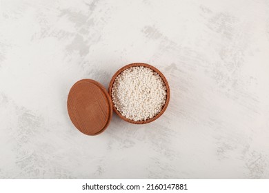 White Sago Pearls Or Tapioca Pearl In Wooden Bowl, Top View. Manioc Granule Starch.