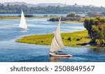 White sailing Felucca sailboats on River Nile, Aswan, Egypt