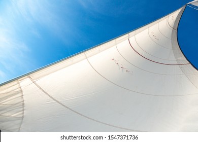 White Sails On The Background Of Blue Sky In The Tropics. Sailing Yacht On Vacation In The Ocean. Mast, Boom, Halyard, Wind-filled Sails - Jib, Spinnaker, Genoa, Mainsail. Rig, Rope, Backstay In Thai