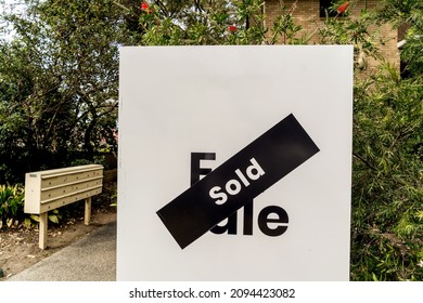 White For Sale Sign Near The Resedential Appartment Building With Sold Sticker On It. Real Estate Property Investment Boom