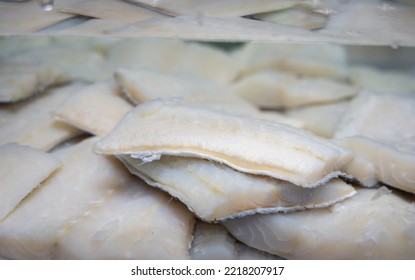 White salted and dried bacalao codfish in watertank, traditional Spanish preserved seafood on display in fish shop