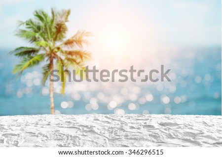 white sand beach on coconut tree and bokeh light sea background