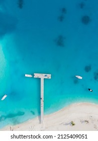 White Sand Beach And Port Pier With Transparent Blue And Turquoise Water, Aerial Top Down View From Drone On Tropical Island In Maldives. Beautiful Vacation Travel Destination.