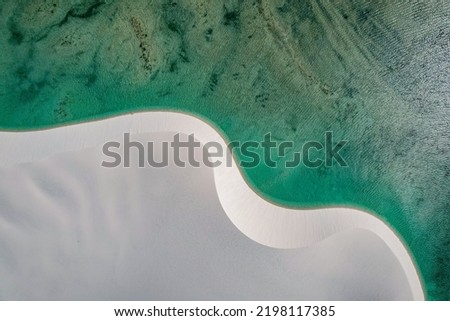 
White sand dunes among lakes with blue water, aerial view