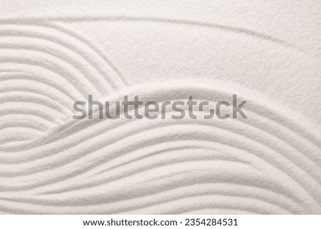 White sand with pattern as background, top view. Concept of zen and harmony