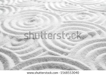 White sand with pattern as background. Zen, meditation, harmony
