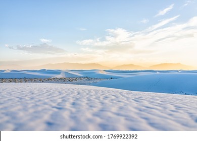 White Sands Dunes National Park Monument Hills Of Gypsum Sand In New Mexico With Organ Mountains Silhouette On Horizon During Colorful Yellow Sunset