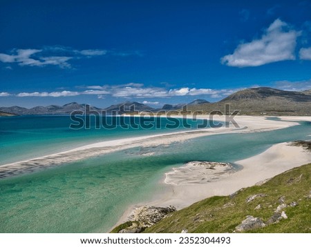 The white sands and turquoise waters of the pristine Luskentyre Bay in the Outer Hebrides. Taken on a sunny day in summer.