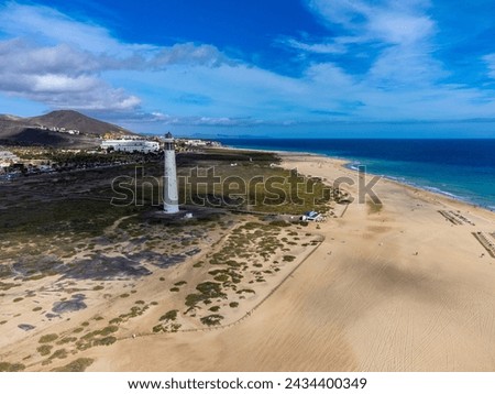 White sandy beach and blue ocean water in Morro Jable vacation village on south of Fuerteventura, Canary islands, Spain in winter