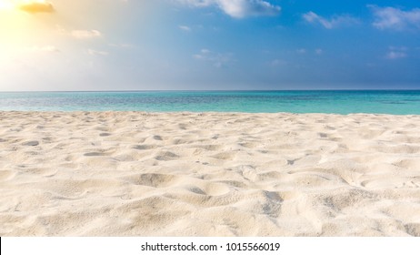 White sandy tropical beach and soft sunlight background and banner - Shutterstock ID 1015566019