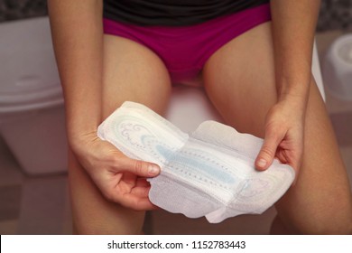 White Sanitary Pad In Hands Of Woman