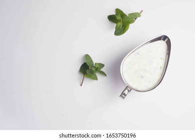 White Sauce With Spices In A Gravy Boat On A White Background