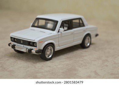 White scale model of sedan. Features precise diecast details, iconic classic design, and chrome accents. Perfect for automotive collectibles, hobbyists, or vintage car stock photography.