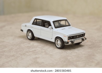 White scale model of sedan. Features precise diecast details, iconic classic design, and chrome accents. Perfect for automotive collectibles, hobbyists, or vintage car stock photography.