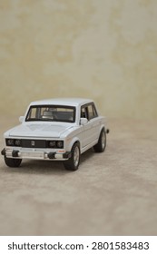 White scale model of sedan. Features precise diecast details, iconic classic design, and chrome accents. Perfect for automotive collectibles, hobbyists, or vintage car stock photography.