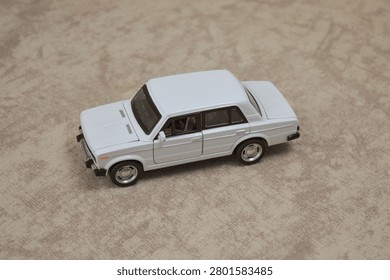 White scale model sedan. Features precise diecast details, iconic classic design, and chrome accents. Perfect for automotive collectibles, hobbyists, or vintage car stock photography.