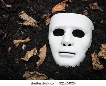 White Scary Halloween Mask On The Ground