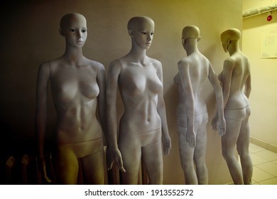 White Scary Mannequins Stand And Look At Each Other With Their Eyes