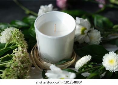 White Scented Candle And Delicate Flowers. Home Fragrances For Relaxation And Calm. Flower Fragrance For Home. Unbranded Ceramic Candle.