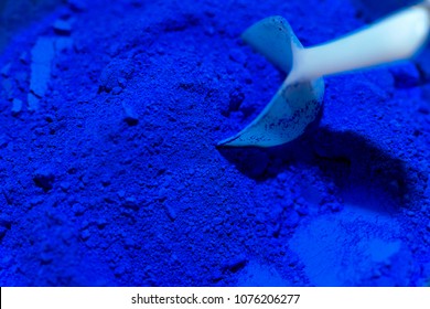 White scoop with ultramarine blue color pigments - Shutterstock ID 1076206277