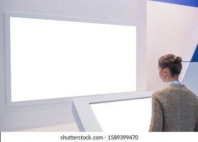 White Screen, Mock Up, Future, Copyspace, Template, Isolated, Technology Concept. Woman Looking At Blank Digital Interactive White Display Wall At Exhibition Or Museum With Futuristic Scifi Interior