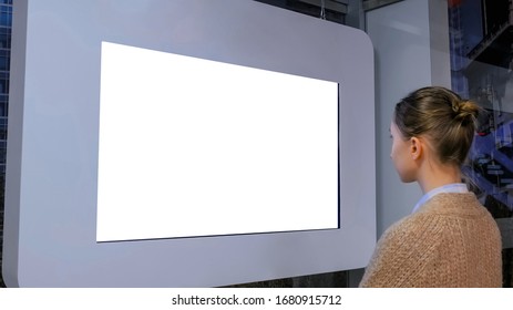 White Screen, Mock Up, Future, Copyspace, Template, Isolated, Technology Concept. Woman Looking At Blank Digital Interactive White Display Wall At Exhibition Or Museum With Futuristic Scifi Interior