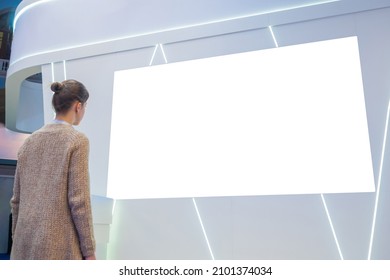 White Screen, Mock Up, Future, Copyspace, Template, Isolated, Technology Concept. Woman Looking At Blank Digital Interactive White Display Wall At Exhibition Or Museum With Futuristic Scifi Interior