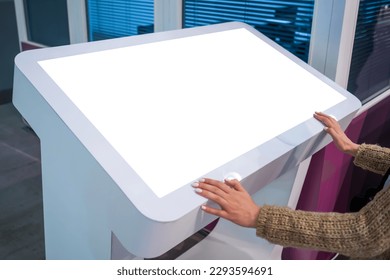 White screen, mock up, future, copyspace, template, technology concept. Woman looking at blank interactive touchscreen white display of electronic kiosk at futuristic exhibition or museum - Shutterstock ID 2293594691