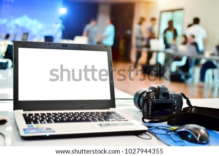White screen notebook with camera on table in the meeting room at office.Business Photography Seminar.For mockup and Advertising.Concept of skill development for success.Training